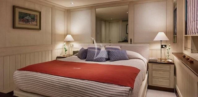 a bedroom with a bed and a lamp aboard ANCALLIA Yacht for Sale