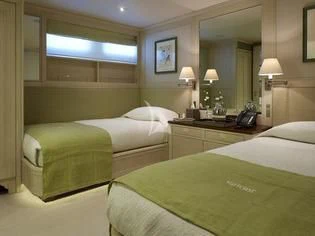a couple of beds in a hotel room aboard ANCALLIA Yacht for Sale