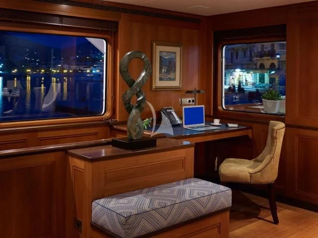 a laptop sits on a desk aboard ANCALLIA Yacht for Sale