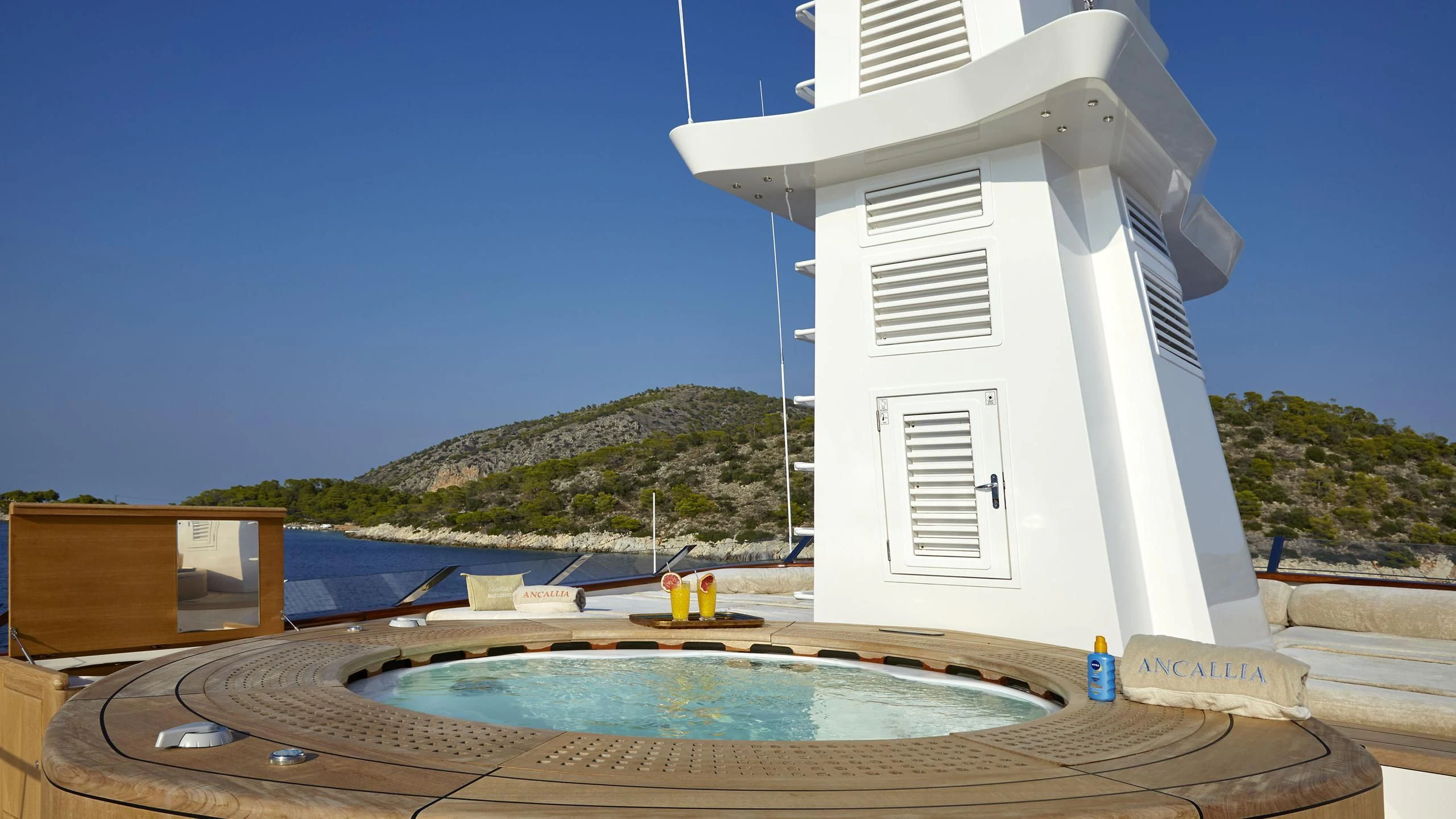 a pool with a pool in the background aboard ANCALLIA Yacht for Sale