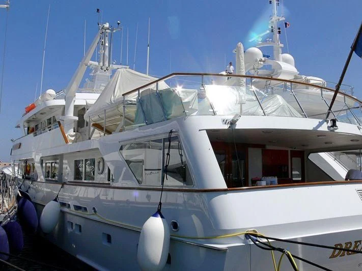 a white boat with blue and red sails aboard ANCALLIA Yacht for Sale