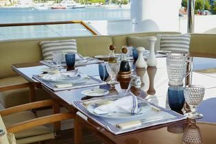 a table set with wine glasses aboard ANCALLIA Yacht for Sale