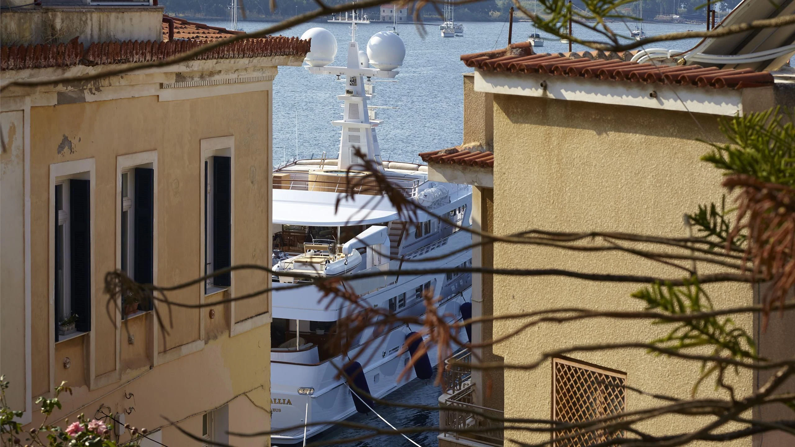 a group of buildings with a boat in the water aboard ANCALLIA Yacht for Sale