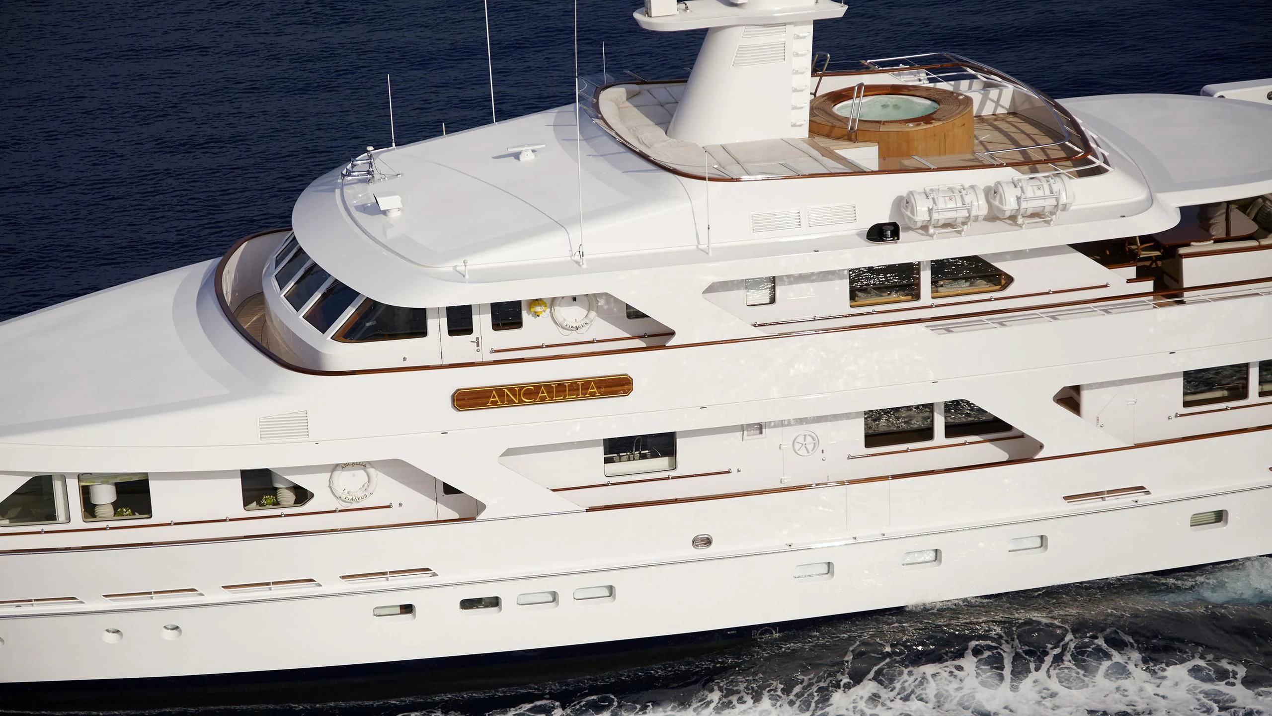a white yacht on the beach aboard ANCALLIA Yacht for Sale