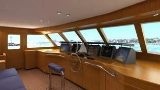 a room with a large window and a desk with computers on it aboard ANCALLIA Yacht for Sale