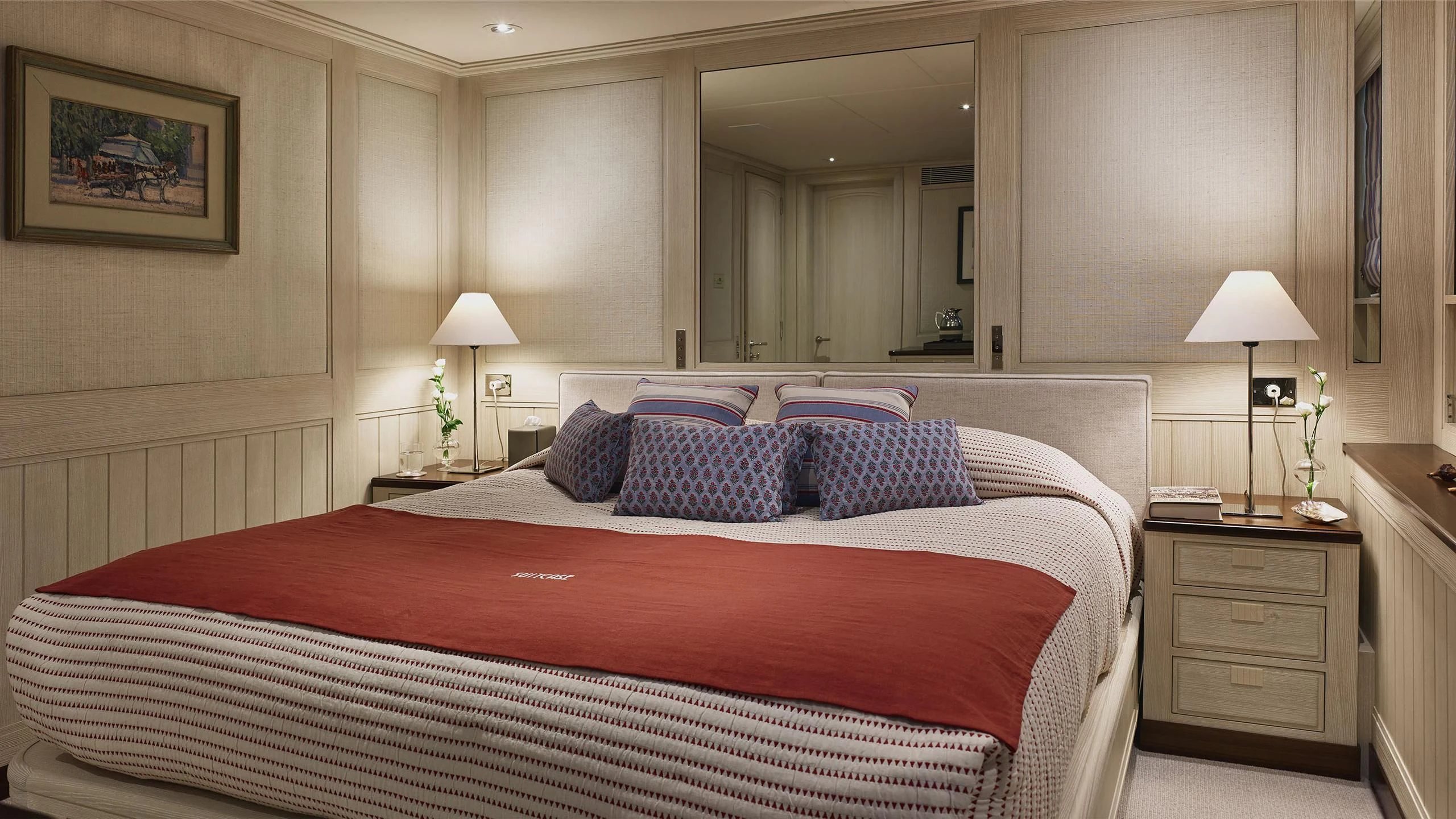 a bed with a red and blue blanket aboard ANCALLIA Yacht for Sale