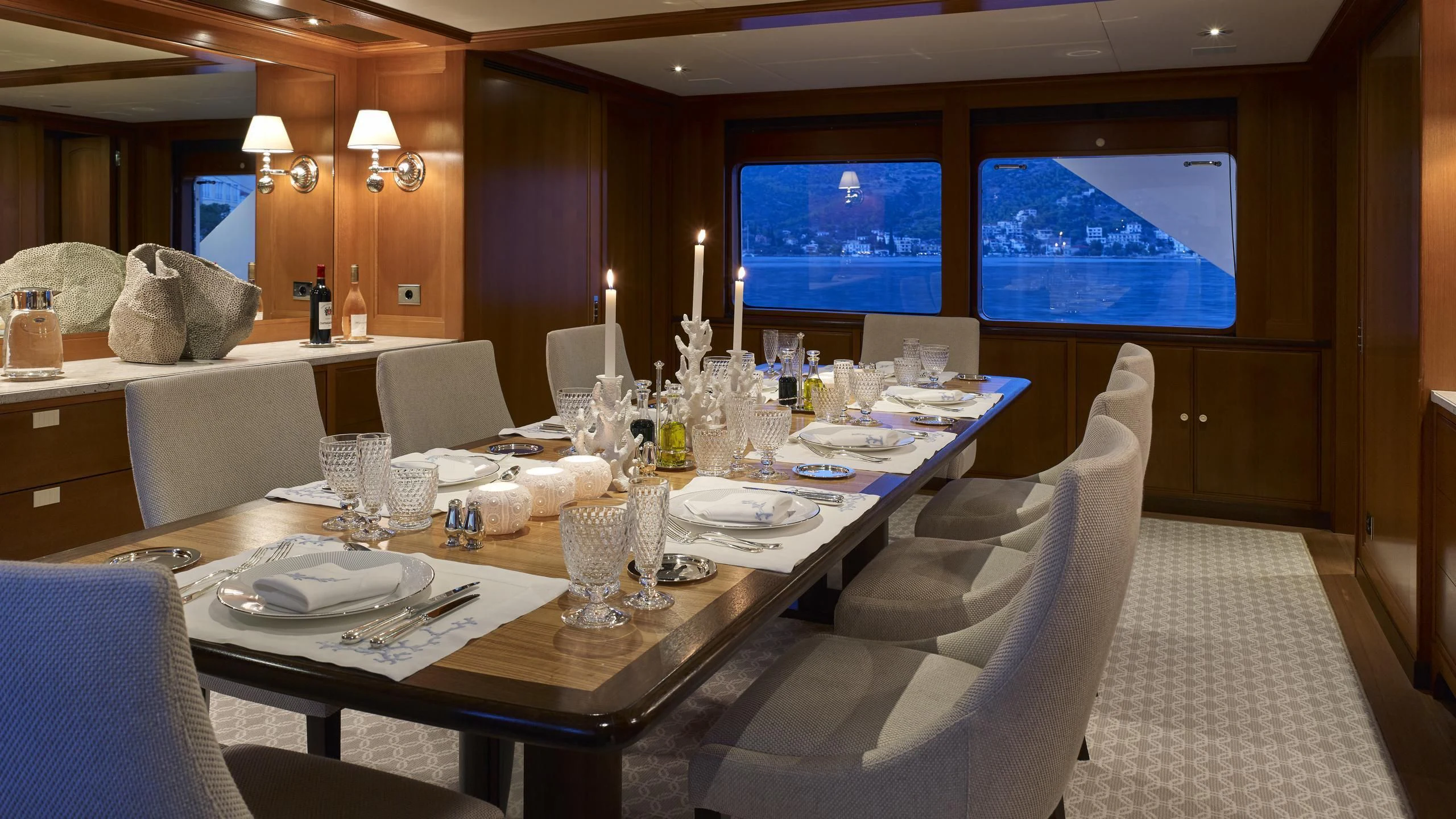 a large dining table with white chairs aboard ANCALLIA Yacht for Sale