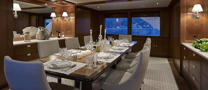 a large dining table with chairs aboard ANCALLIA Yacht for Sale