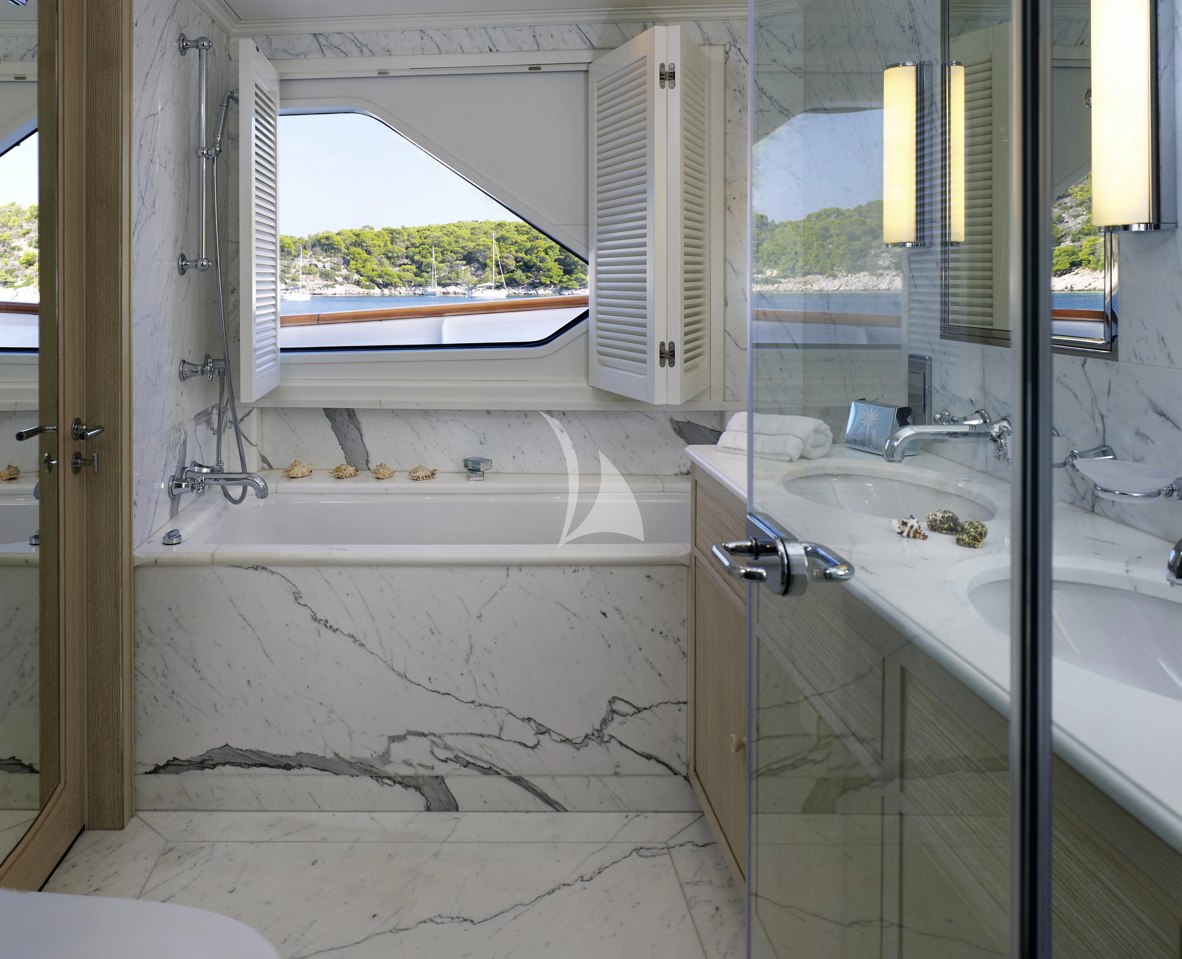 a bathroom with a tub and sink aboard ANCALLIA Yacht for Sale