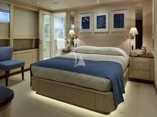 a bedroom with a bed and a chair aboard ANCALLIA Yacht for Sale