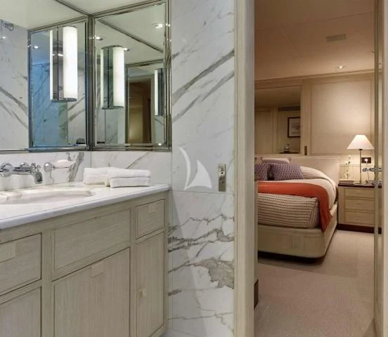 a bathroom with a sink and a bed aboard ANCALLIA Yacht for Sale
