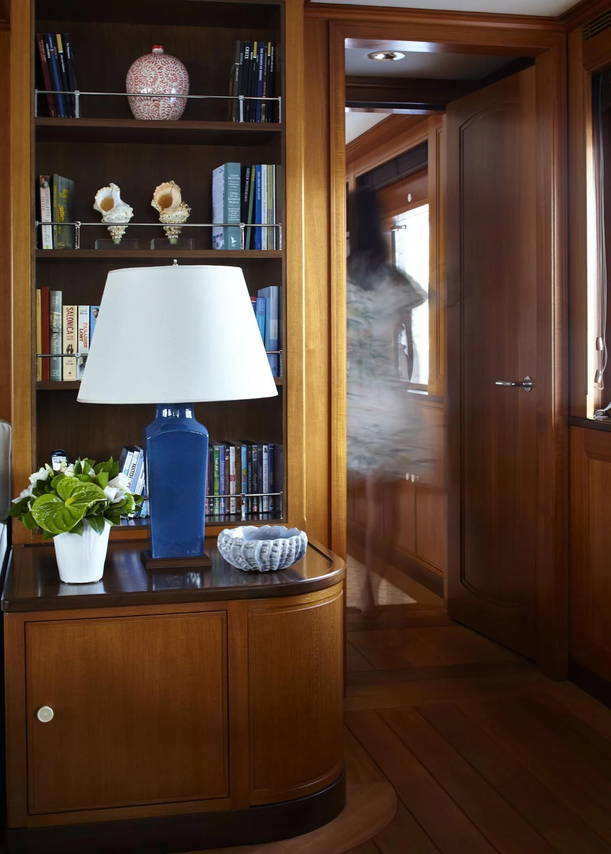 a lamp on a desk in a room with a bookcase aboard ANCALLIA Yacht for Sale