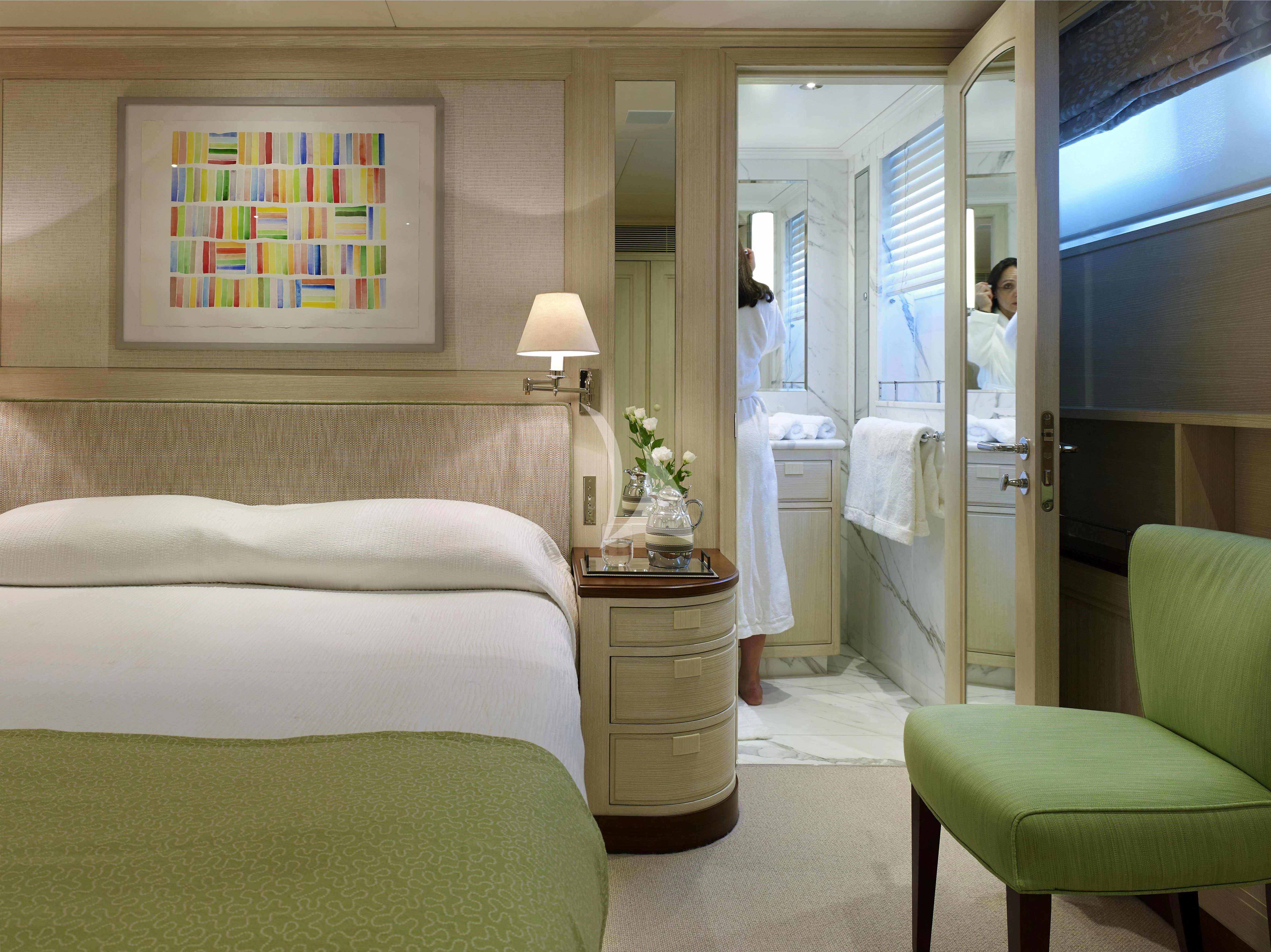 a room with a bed and a mirror aboard ANCALLIA Yacht for Sale