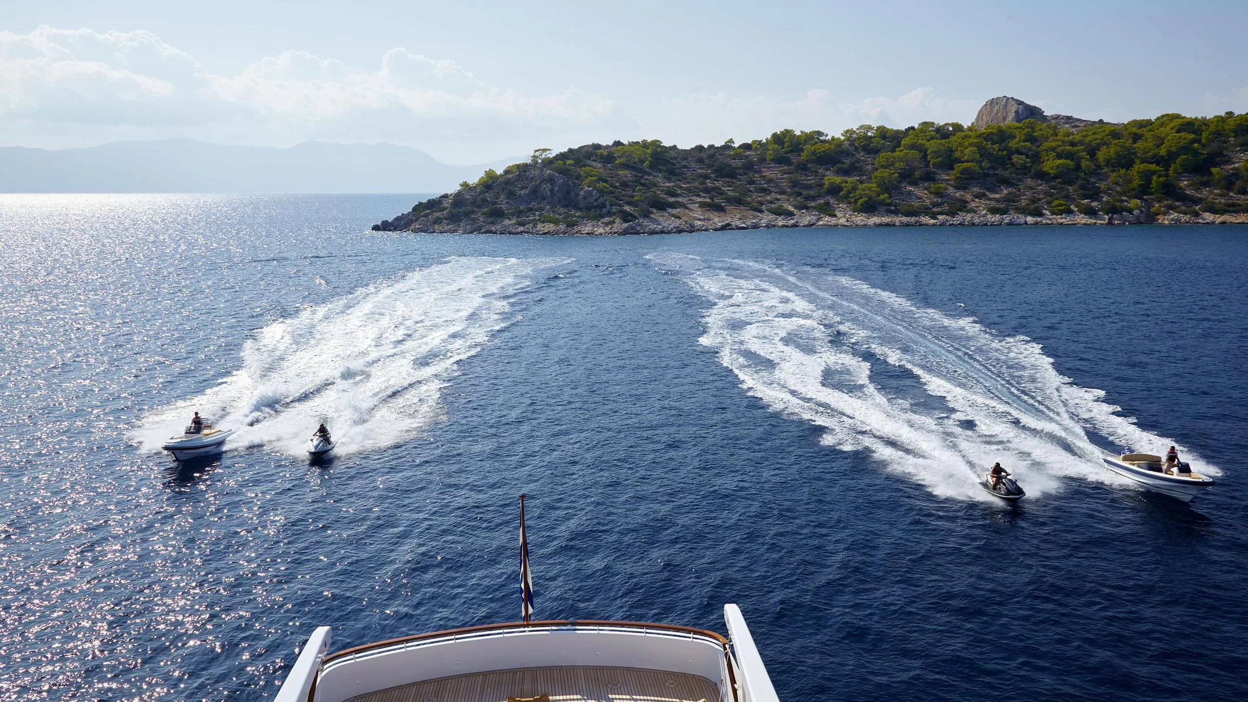 a group of people on jet skis in the water aboard ANCALLIA Yacht for Sale