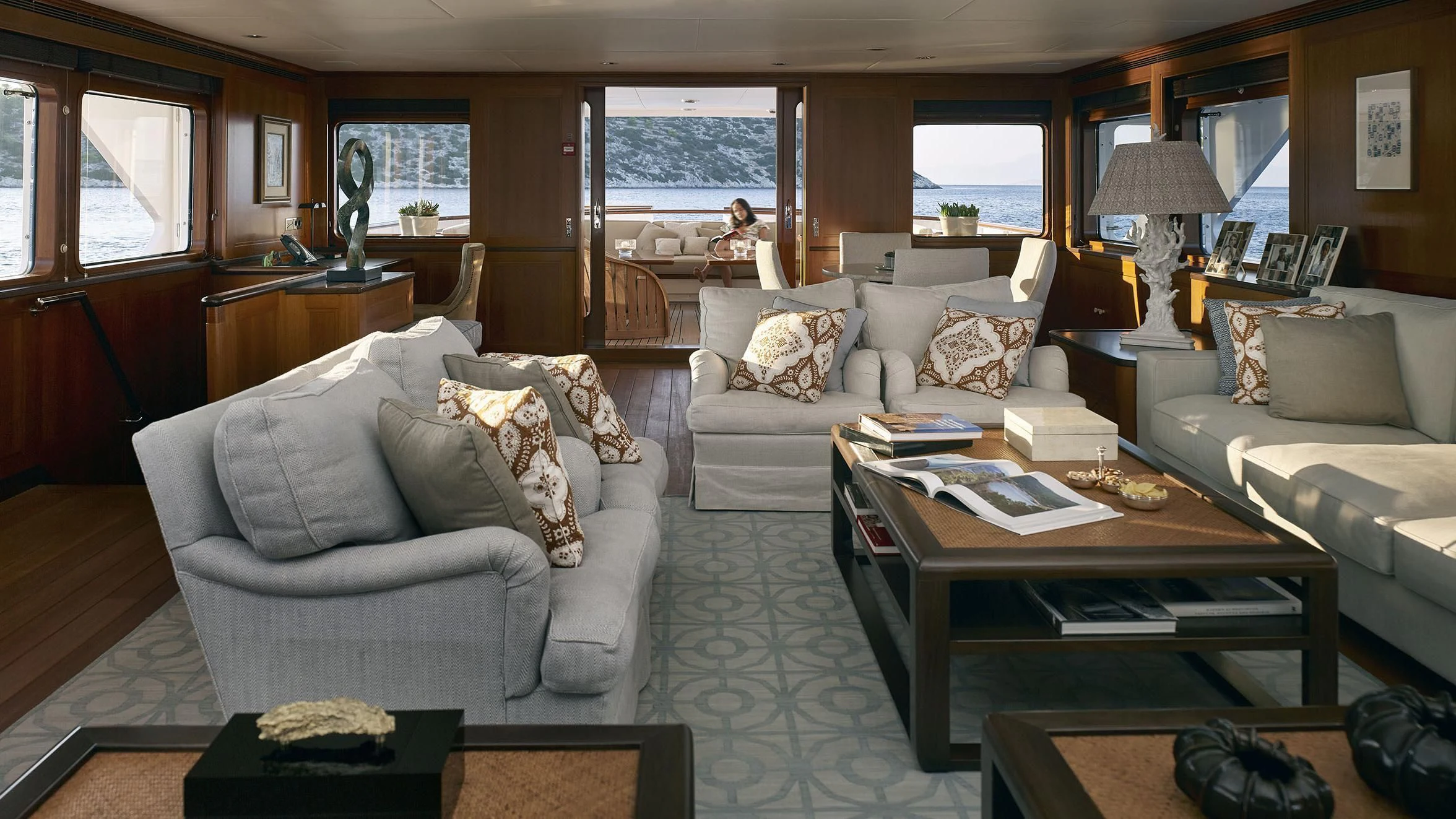 a living room with a person sitting on the couch aboard ANCALLIA Yacht for Sale