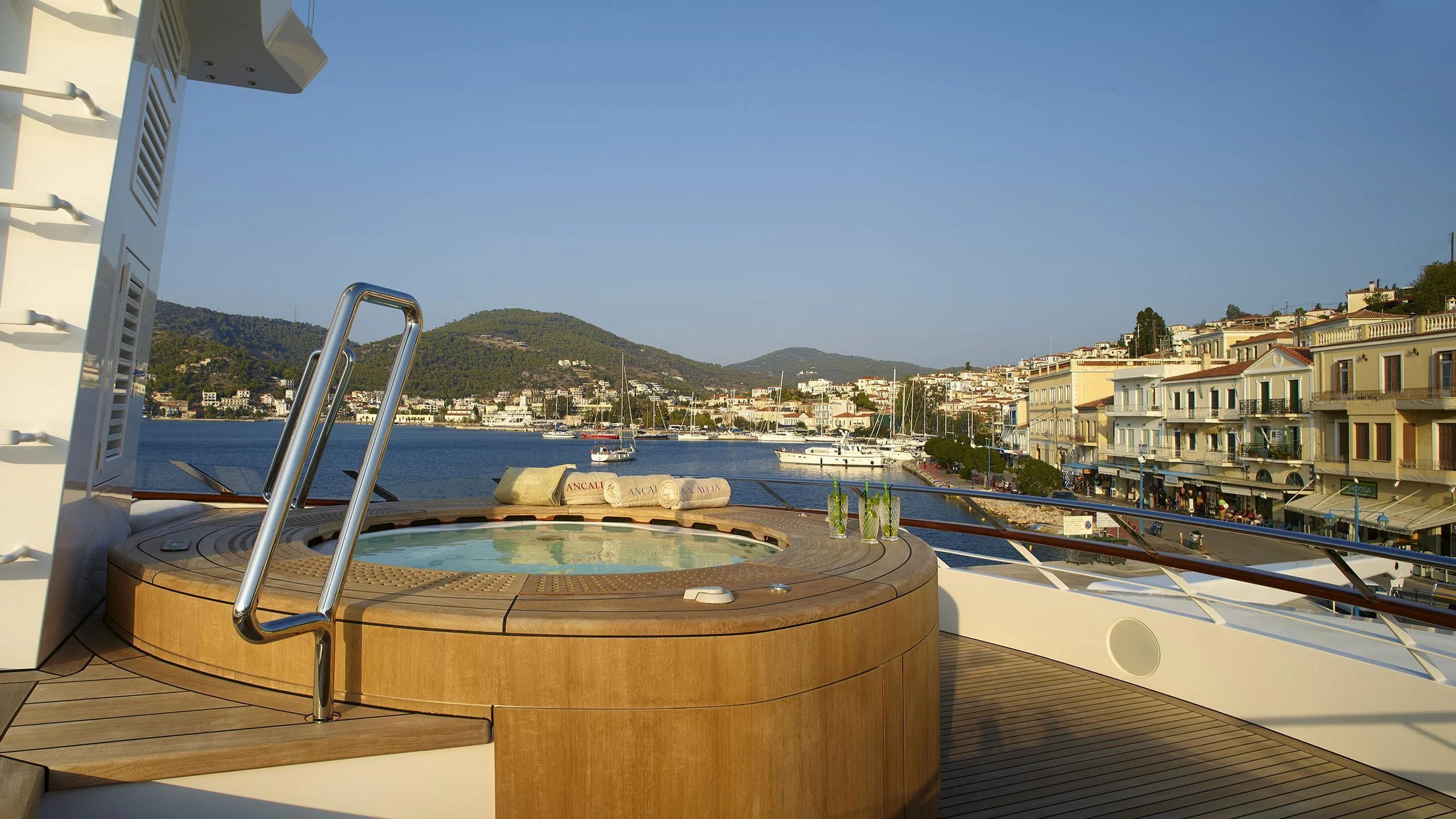 a deck with a view of a city and water aboard ANCALLIA Yacht for Sale