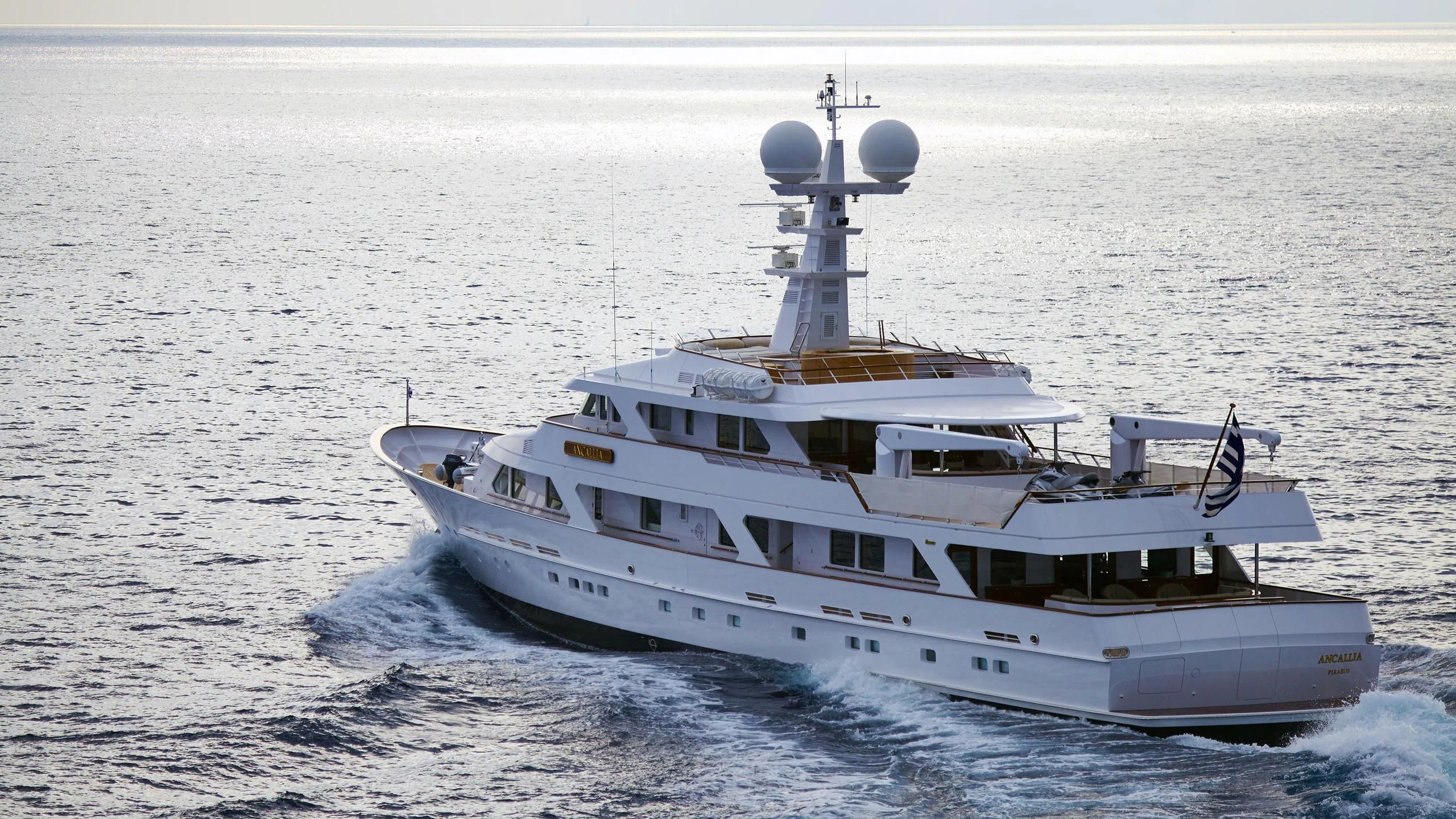 a white boat on the water aboard ANCALLIA Yacht for Sale