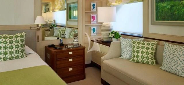 a bedroom with a bed and a desk aboard ANCALLIA Yacht for Sale