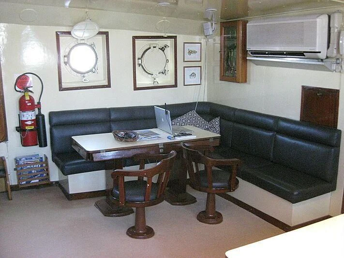 a living room with a couch and a table aboard FLAMINGO BAY Yacht for Sale