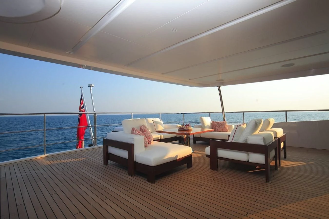 a room with a wood floor and a red flag on the wall aboard LADY MRD Yacht for Charter