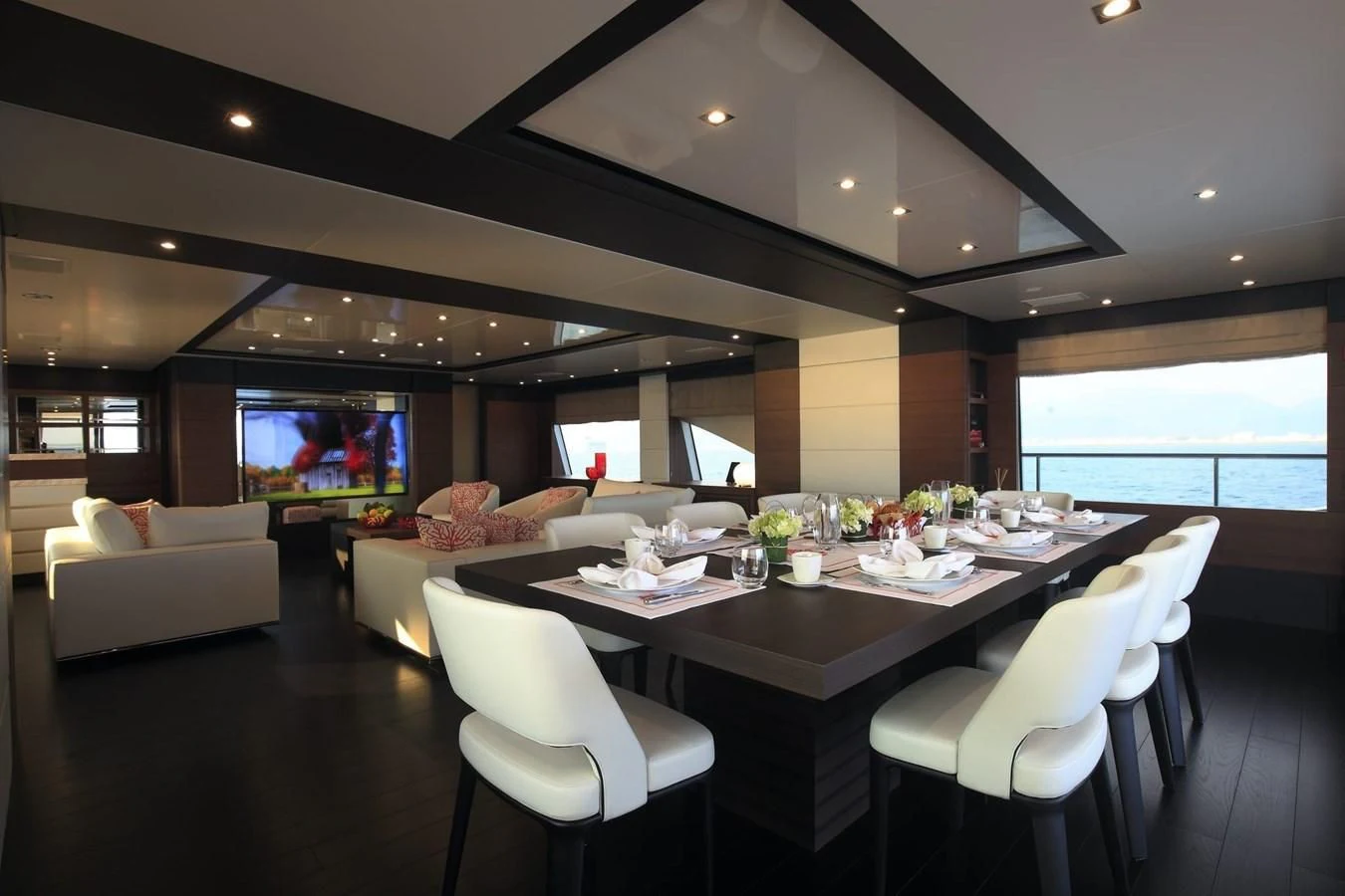 a room with a table chairs and a television aboard LADY MRD Yacht for Charter