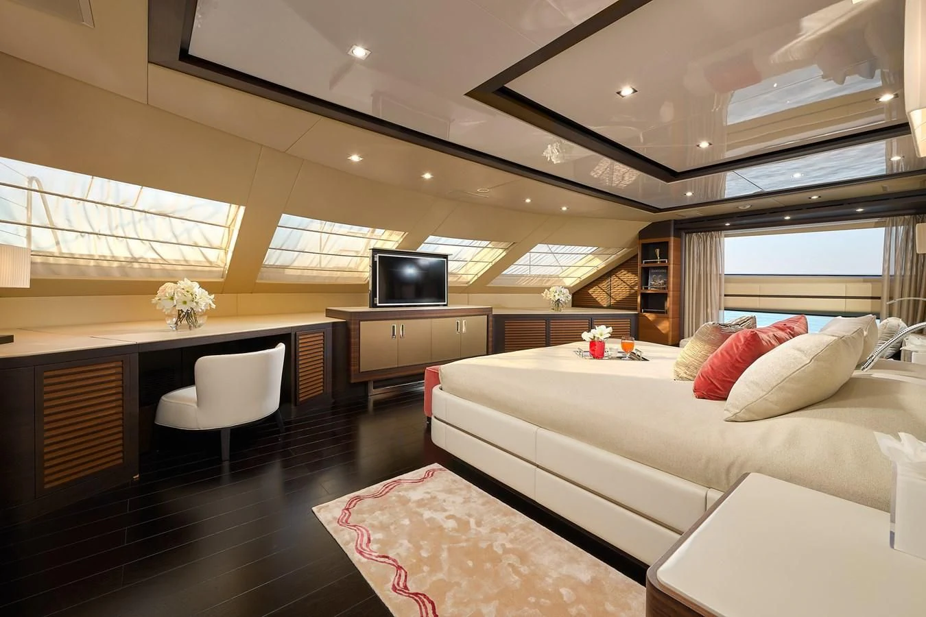 a bedroom with a bed and a tv aboard LADY MRD Yacht for Charter