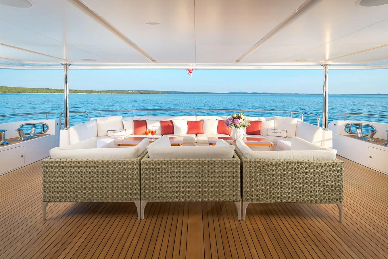 a room with chairs and tables on a deck by the ocean aboard LADY MRD Yacht for Charter