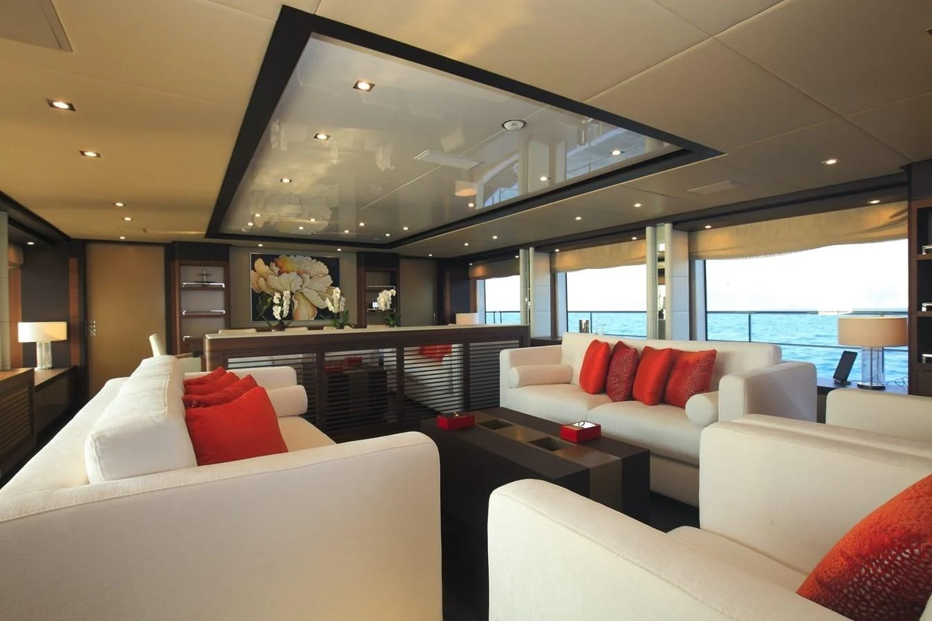 a room with a couch and a table with a window aboard LADY MRD Yacht for Charter
