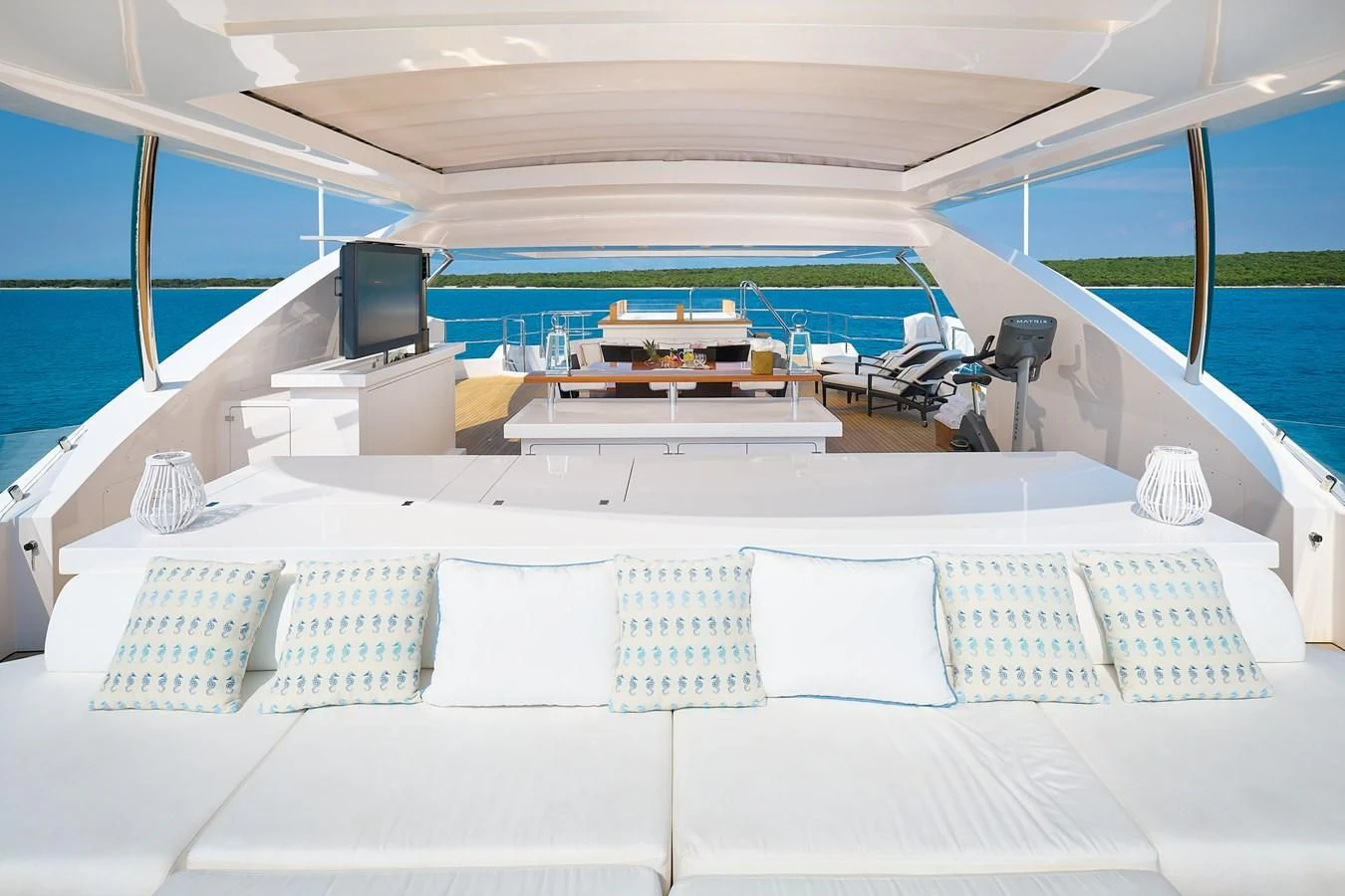 a large white lounge chair in a room with a pool and a large window aboard LADY MRD Yacht for Charter