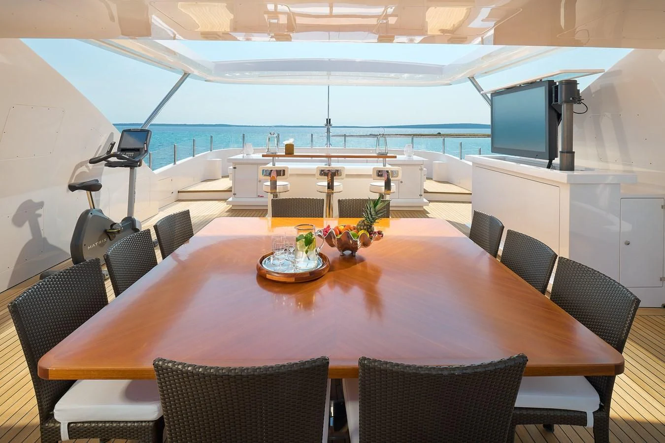 a table with chairs and a television on it aboard LADY MRD Yacht for Charter