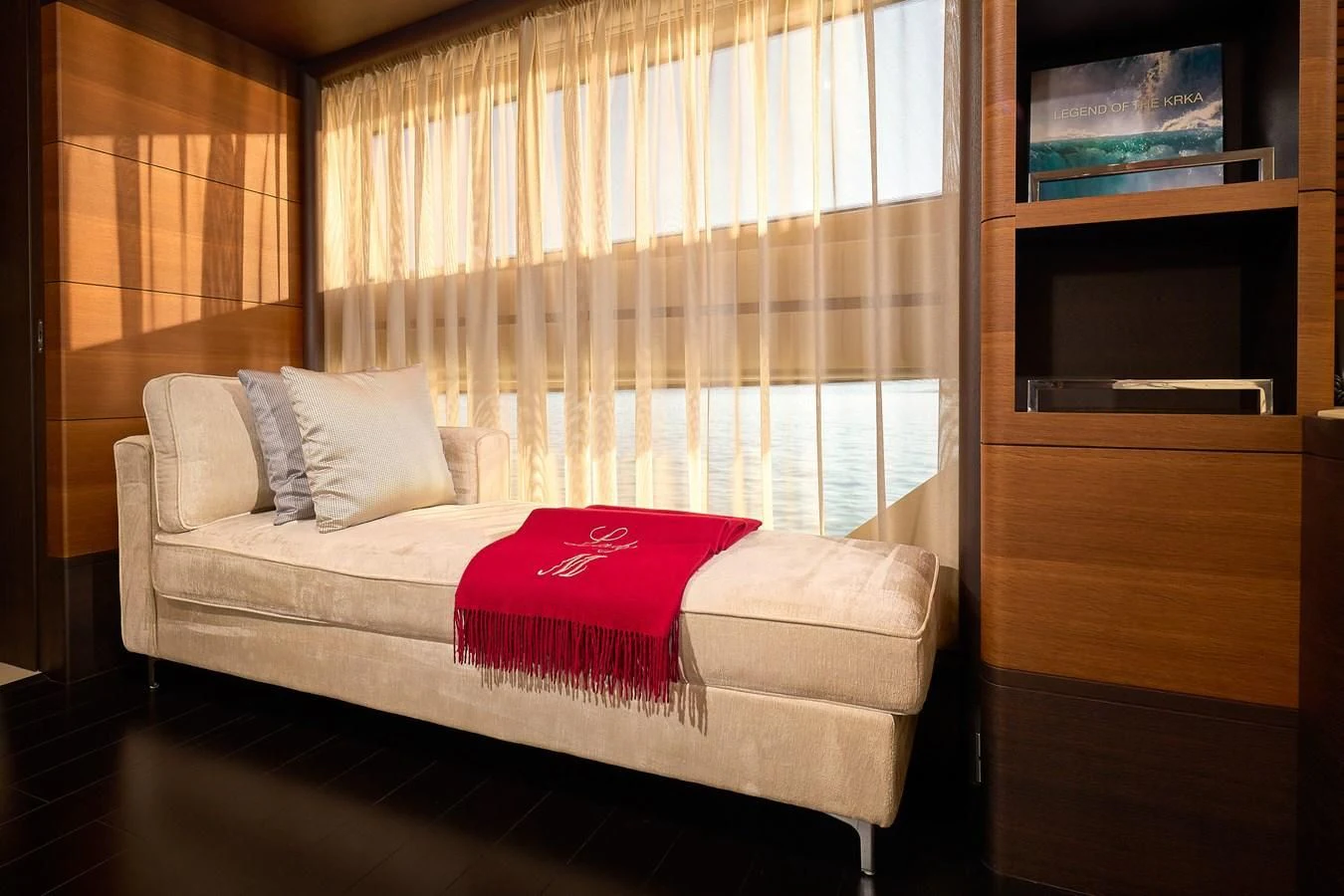 a bed with a red pillow aboard LADY MRD Yacht for Charter