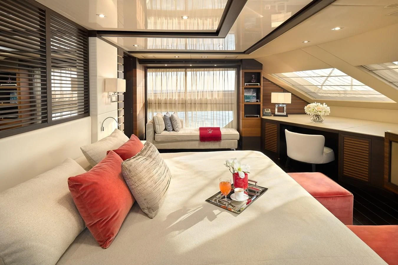 a bed with a white sheet and red pillows aboard LADY MRD Yacht for Charter