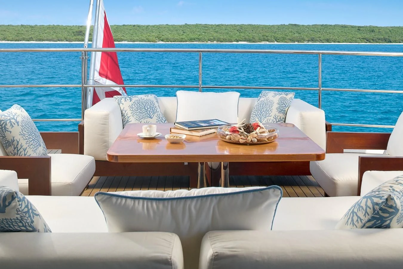 a table with chairs and a flag on it aboard LADY MRD Yacht for Charter