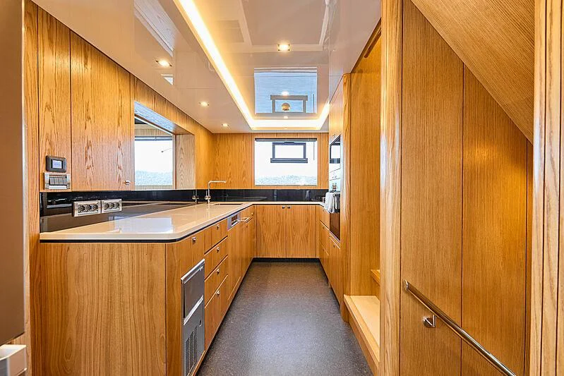 a kitchen with wooden cabinets aboard VERONIKA Yacht for Sale