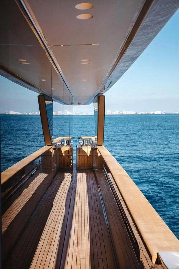a deck with chairs on it by the water aboard PEARL Yacht for Sale