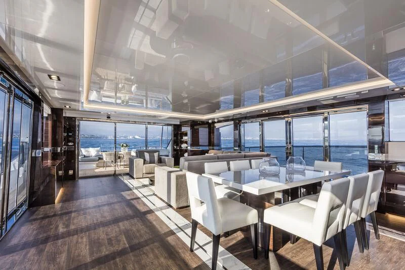 a room with tables and chairs aboard PEARL Yacht for Sale