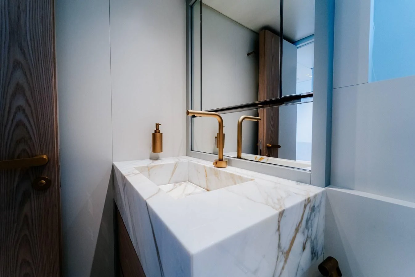 a bathroom with a tub sink and mirror aboard PEARL Yacht for Sale