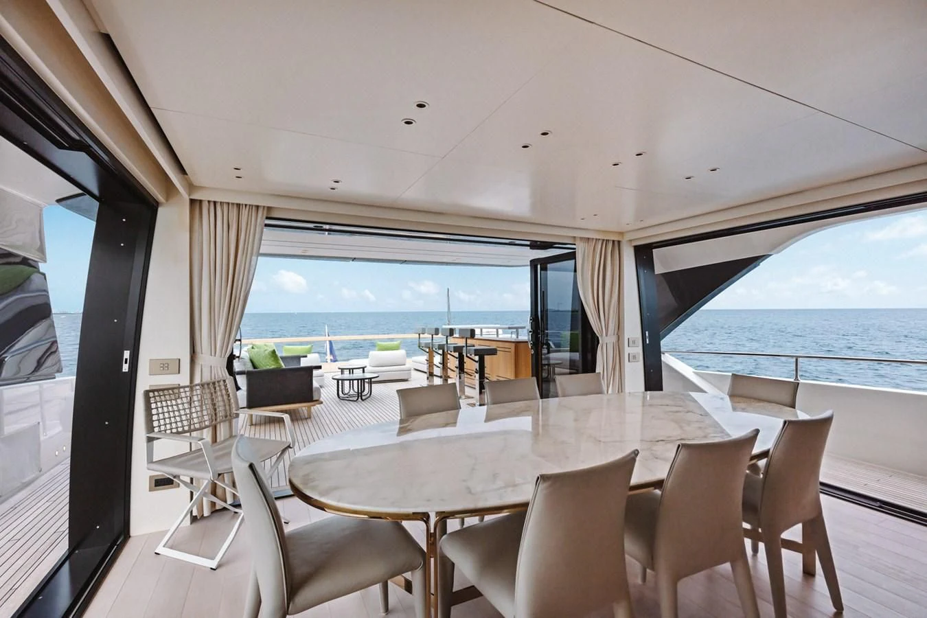 a room with tables and chairs aboard PEARL Yacht for Sale