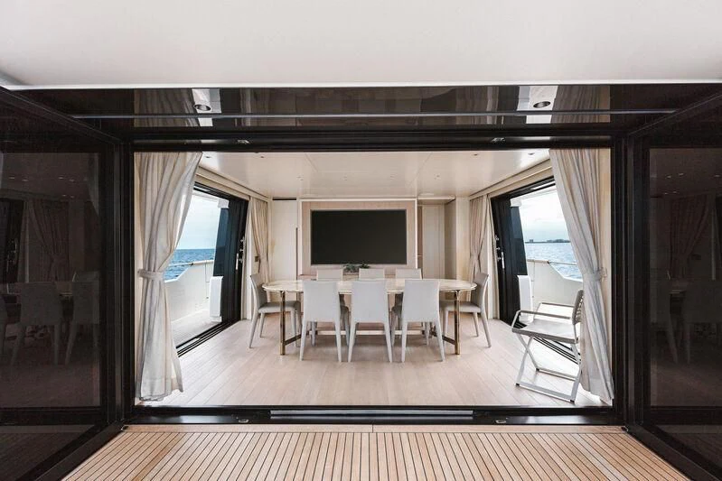 a room with a table and chairs aboard PEARL Yacht for Sale