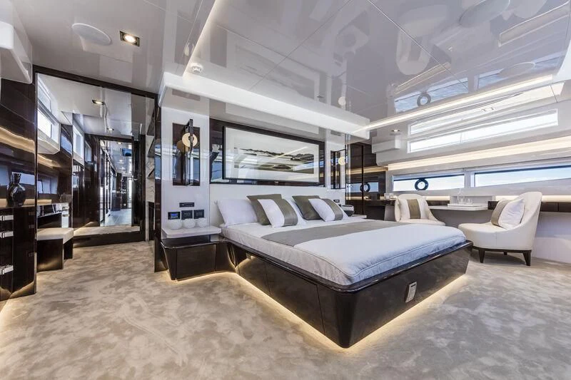 a room with a bed and a chair aboard PEARL Yacht for Sale