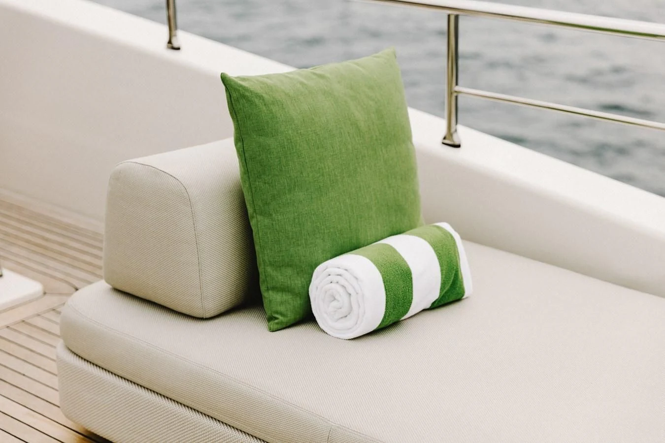 a green and white pillow on a white surface aboard PEARL Yacht for Sale