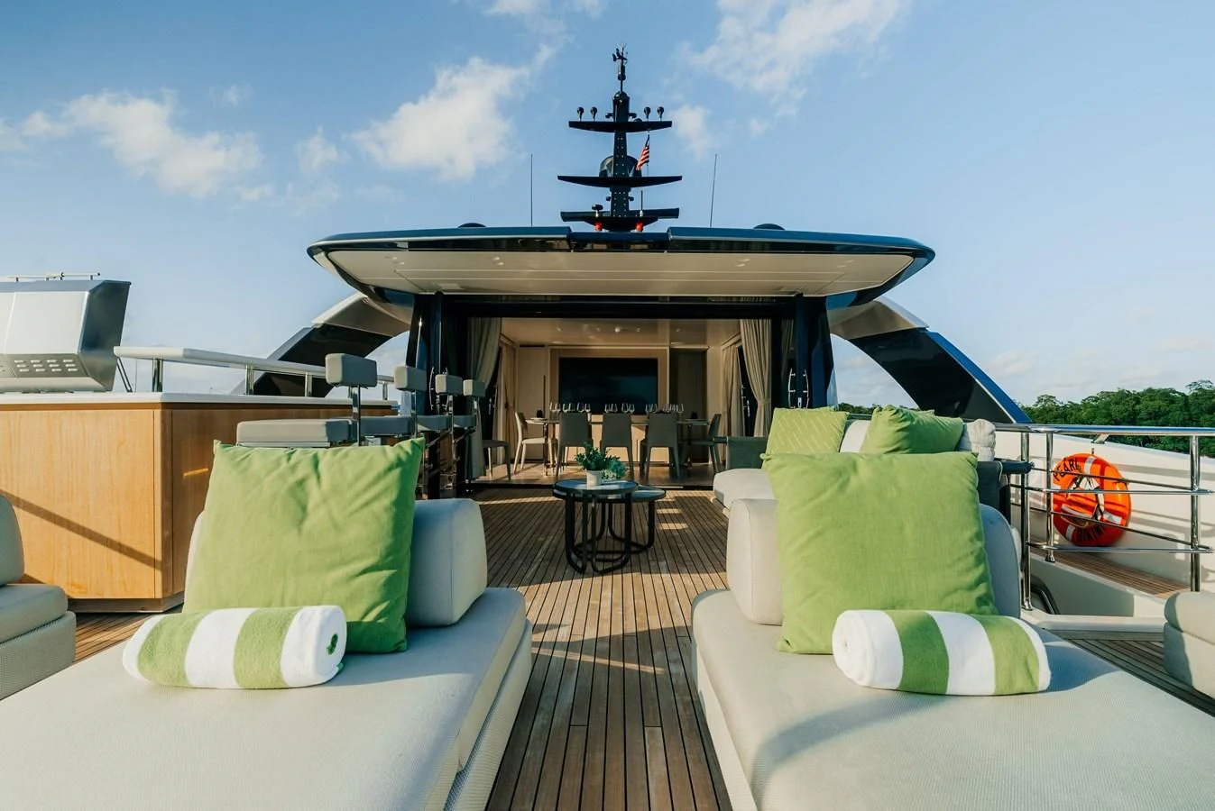 a room with a couch and a fireplace and a large ship in the background aboard PEARL Yacht for Sale