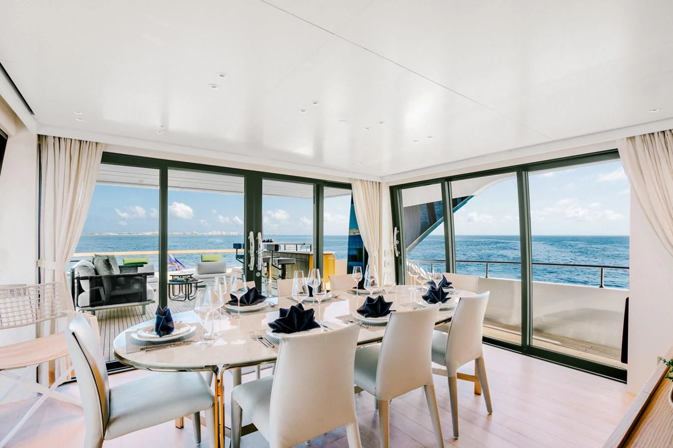 a room with a table and chairs aboard PEARL Yacht for Sale