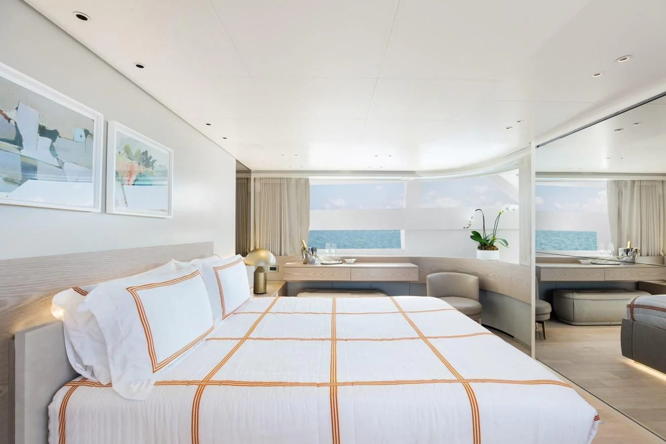 a modern bedroom with a large bed aboard PEARL Yacht for Sale