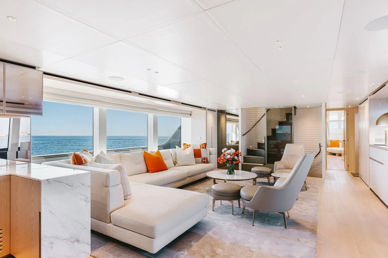 a living room with white furniture aboard PEARL Yacht for Sale