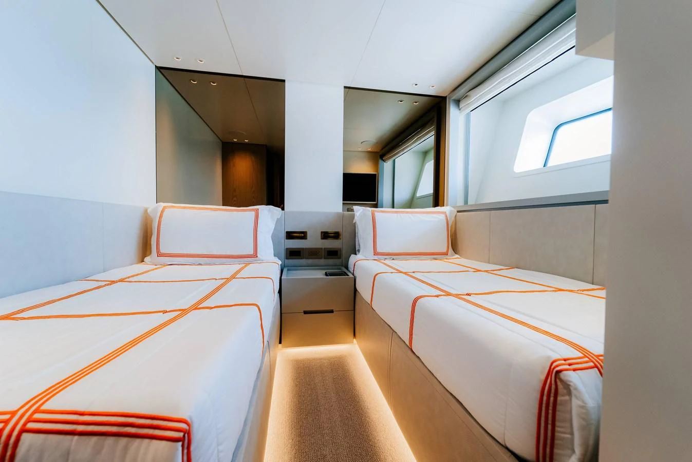 a room with beds and a chair aboard PEARL Yacht for Sale