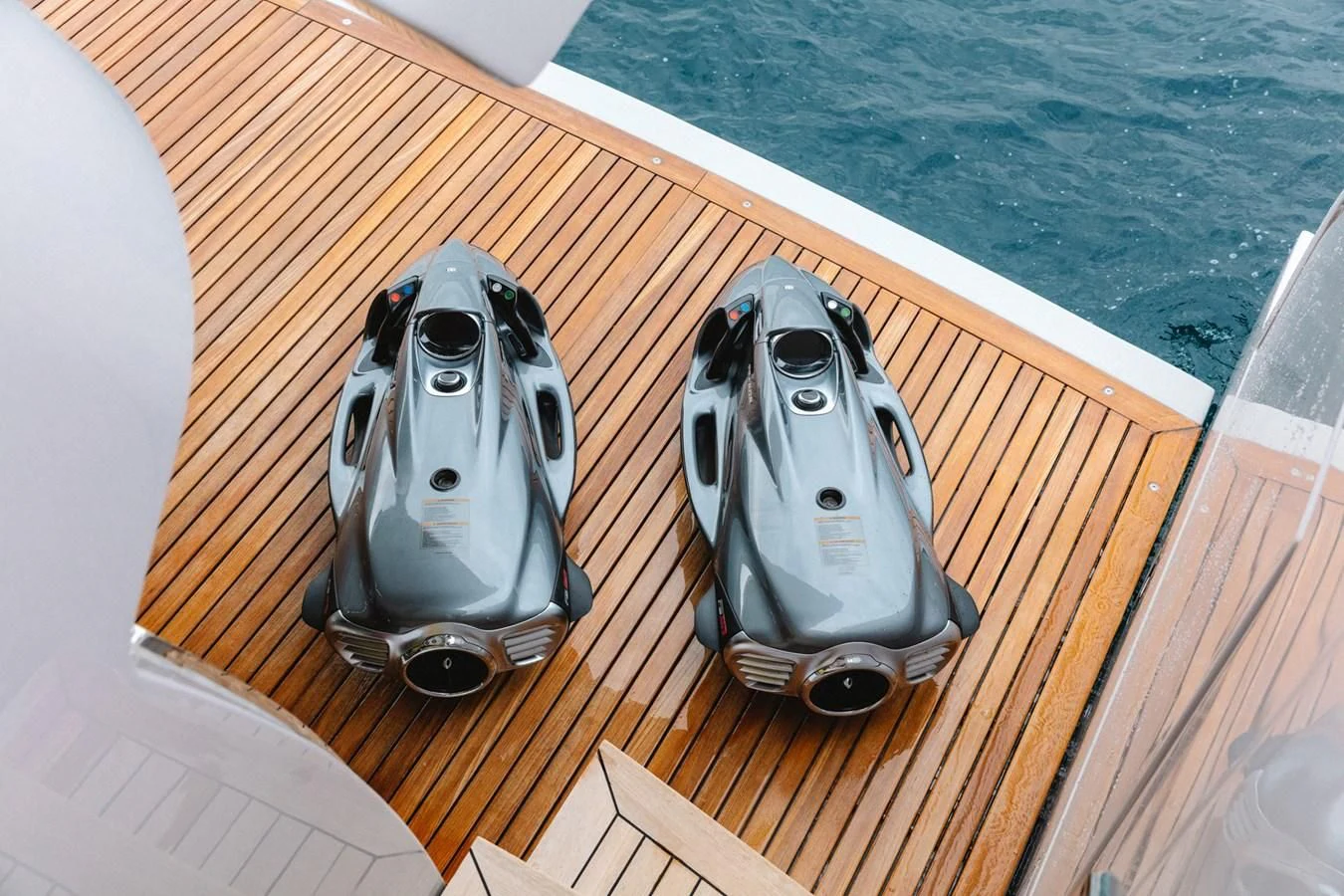 two silver and black helmets on a wooden surface aboard PEARL Yacht for Sale