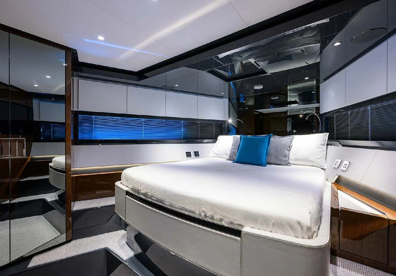 a room with a bed and a mirror aboard JACQPOT Yacht for Sale