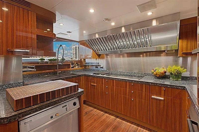 a kitchen with wooden cabinets aboard GROOVER Yacht for Sale