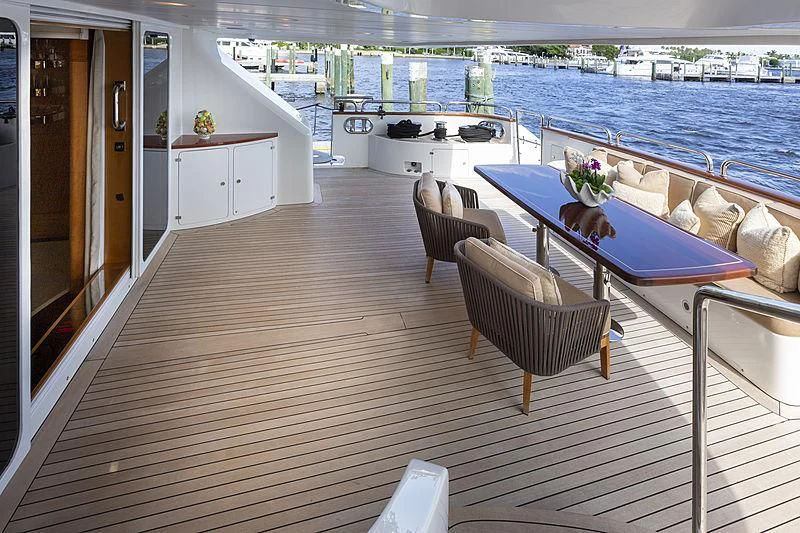 a deck with a table and chairs aboard GROOVER Yacht for Sale